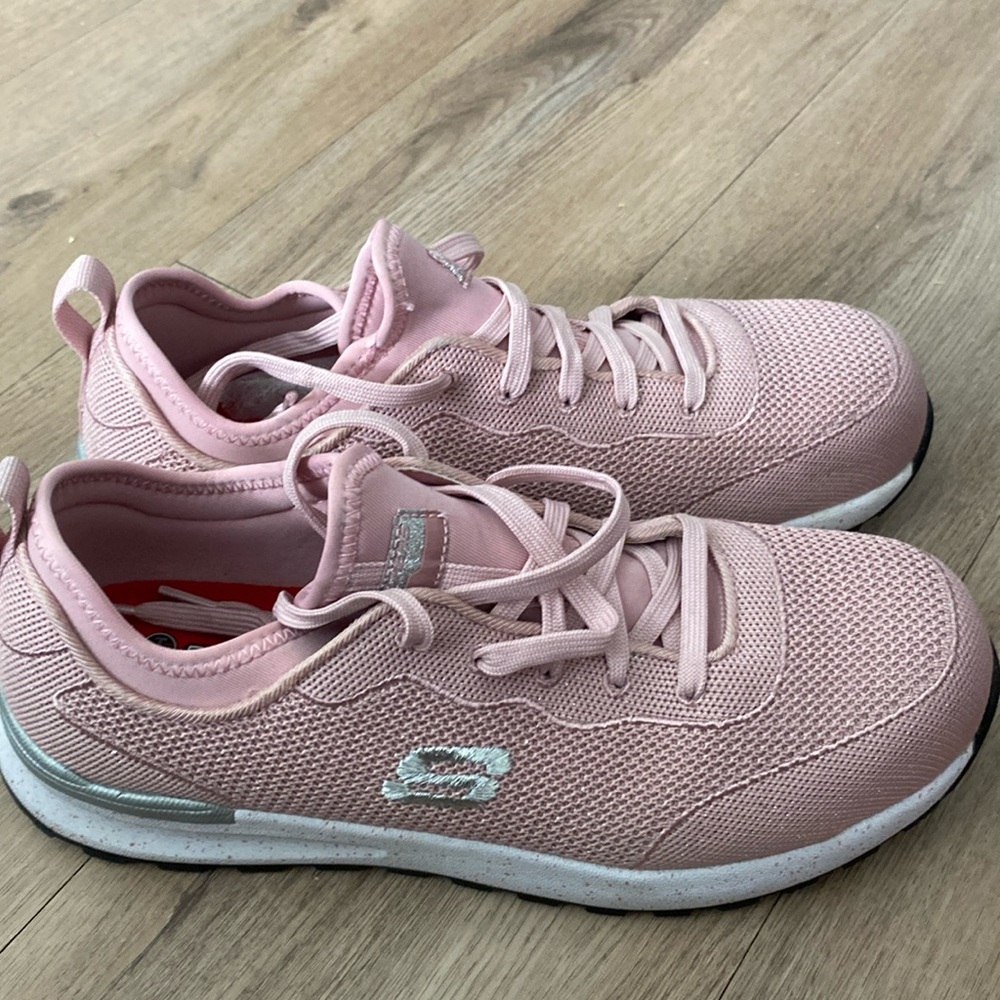 A pair of sparkling pink tennis shoes and they’re slip resistant steel toe
